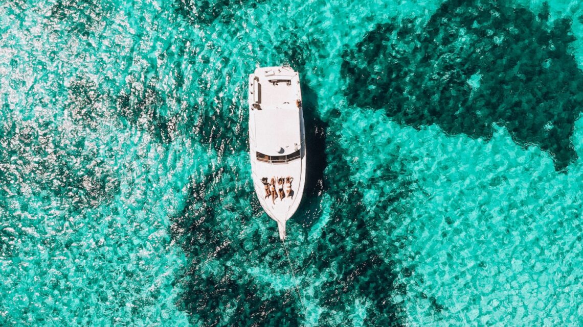 white yacht on body of water