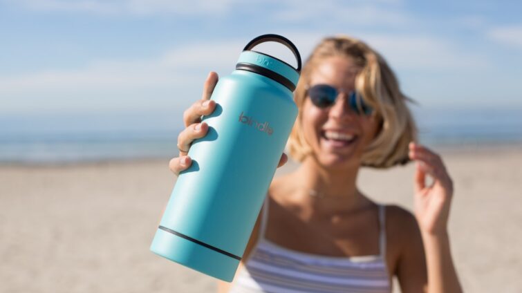 woman holding blue tumbler